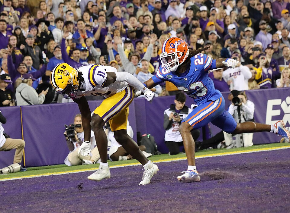 Brian Thomas Jr. carries the football for LSU against Florida in 2023.